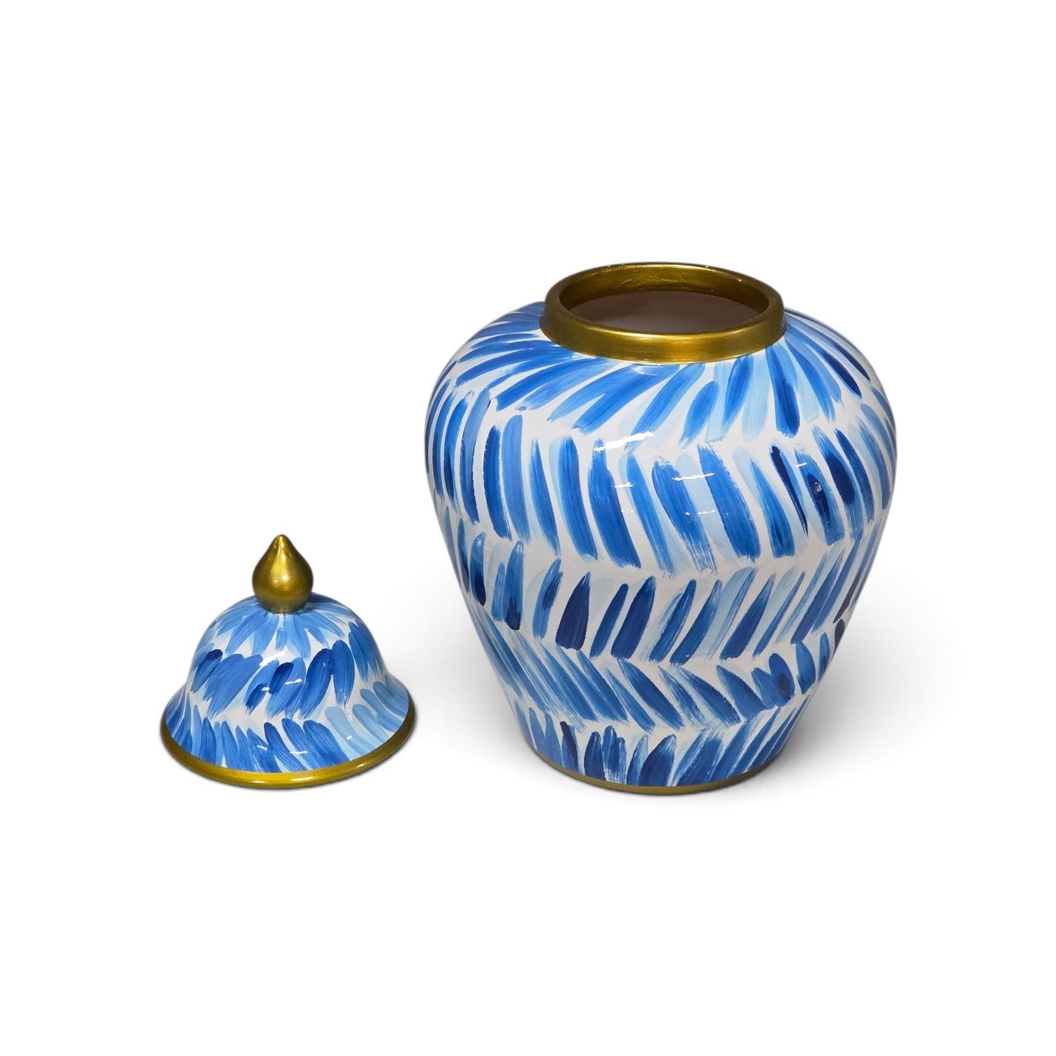 A ceramic lidded vase with a blue and white leaf pattern and gold trim, shown with its lid placed beside the vase on a white background.